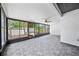 The screened patio offers a fan, updated tile floors, and views of the landscaped yard at 4326 Fern Glen St, Holiday, FL 34691