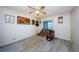 Bedroom featuring wood-look floors, ceiling fan, and a sliding door at 5265 E Bay Dr # 521, Clearwater, FL 33764