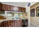 Kitchen featuring wood cabinets, stainless steel sink, and view through to the living area at 5265 E Bay Dr # 521, Clearwater, FL 33764