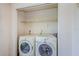 Laundry closet with a wire shelf above a side-by-side washer and dryer at 5265 E Bay Dr # 521, Clearwater, FL 33764