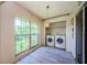 Laundry room featuring a window and side-by-side washer and dryer in a closet at 5265 E Bay Dr # 521, Clearwater, FL 33764