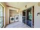 Bright laundry area showcasing modern washer and dryer, decorative sliding doors, and light wood-look flooring at 5265 E Bay Dr # 521, Clearwater, FL 33764
