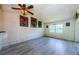 A light filled living room featuring plank flooring and a modern ceiling fan at 5265 E Bay Dr # 521, Clearwater, FL 33764