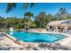 Inviting community pool area featuring a clear blue pool, ample seating, and a nearby pool house for residents at 5265 E Bay Dr # 521, Clearwater, FL 33764