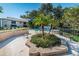 Pool area with lounge seating for relaxing poolside, surrounded by greenery and palm trees near residential buildings at 5265 E Bay Dr # 521, Clearwater, FL 33764