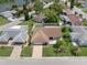 Charming home showcases a spacious driveway and lush landscaping, enhanced by a fenced backyard at 7022 Kingsway Dr, Port Richey, FL 34668