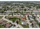 An aerial view shows a home's position within a suburban neighborhood filled with mature trees at 7022 Kingsway Dr, Port Richey, FL 34668