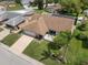 Beautiful home with manicured lawn, mature trees, and inviting patio area at 7022 Kingsway Dr, Port Richey, FL 34668