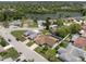 Aerial view showcasing the property's location near a lake and surrounded by lush greenery at 7022 Kingsway Dr, Port Richey, FL 34668