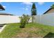 Well-maintained backyard featuring lush grass and privacy fencing at 7022 Kingsway Dr, Port Richey, FL 34668
