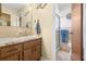 Bathroom with wooden vanity, nautical decor, and walk-in shower at 7022 Kingsway Dr, Port Richey, FL 34668