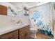 Bathroom with single vanity, wall art, decorative shower curtain at 7022 Kingsway Dr, Port Richey, FL 34668