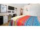 Bedroom with wood flooring and an adjacent desk and workstation at 7022 Kingsway Dr, Port Richey, FL 34668