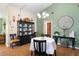 Charming dining room with a round table, modern chandelier, and elegant decor at 7022 Kingsway Dr, Port Richey, FL 34668