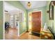 A welcoming foyer with wood flooring and decorative accents, leading to other rooms in the home at 7022 Kingsway Dr, Port Richey, FL 34668