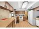 Efficient kitchen with white appliances, ample counter space, and wood-look flooring at 7022 Kingsway Dr, Port Richey, FL 34668