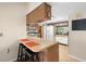 Kitchen counter with stool seating area, wood cabinets and view to a second Kitchen space at 7022 Kingsway Dr, Port Richey, FL 34668