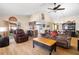 Bright open concept living space with kitchen view, wood flooring, and comfortable seating at 7022 Kingsway Dr, Port Richey, FL 34668