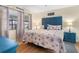 Serene bedroom with coastal decor, wood-look floors, and ample natural light at 7022 Kingsway Dr, Port Richey, FL 34668