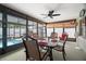 Enclosed patio features a dining set, ceiling fan, and view of the pool at 7022 Kingsway Dr, Port Richey, FL 34668