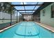 Private screened-in pool featuring a tranquil atmosphere with a hammock for poolside relaxation at 7022 Kingsway Dr, Port Richey, FL 34668