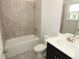 Well-lit bathroom with a tiled shower over tub, vanity with solid surface counter, and neutral color palette at 723 Steel Dr, Apollo Beach, FL 33572