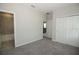Light-filled bedroom with plush carpeting, double door closet, and access to an en-suite bathroom at 723 Steel Dr, Apollo Beach, FL 33572