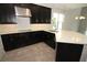 The well-appointed kitchen with dark cabinets and light countertops offers ample space at 723 Steel Dr, Apollo Beach, FL 33572