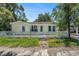 Charming single-story home featuring a cozy front porch and mature trees in a quiet neighborhood at 814 Florida Ave, Palm Harbor, FL 34683