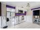 Open kitchen with white cabinets, a microwave, and needs renovation, offering a great opportunity for customization at 814 Florida Ave, Palm Harbor, FL 34683