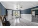 Bright living room with tile flooring, ceiling fan, and light-filled windows, awaiting finishing touches at 814 Florida Ave, Palm Harbor, FL 34683