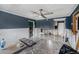 Spacious living room featuring tile floors, ceiling fan and unfinished walls awaiting a personalized design at 814 Florida Ave, Palm Harbor, FL 34683