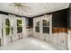 Sunroom with white wood floors and large windows looking onto the yard, with remodel needed at 814 Florida Ave, Palm Harbor, FL 34683