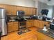 Bright kitchen featuring stainless steel appliances and wood cabinetry at 8405 Costa Bella Way, Temple Terrace, FL 33637