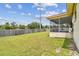 Large, well-maintained backyard featuring a covered patio perfect for outdoor enjoyment and entertaining at 855 Pinewood W Ter, Palm Harbor, FL 34683