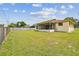 Spacious backyard with well-maintained lawn and a screened patio, ideal for outdoor activities and enjoyment at 855 Pinewood W Ter, Palm Harbor, FL 34683