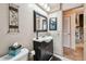 Clean bathroom featuring a vanity, decorative mirrors, neutral walls, and tile flooring at 855 Pinewood W Ter, Palm Harbor, FL 34683