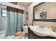 Well-maintained bathroom featuring a vanity sink, toilet, and shower with neutral tones at 855 Pinewood W Ter, Palm Harbor, FL 34683