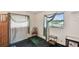 Bright bedroom with a window view, accentuated by stylish curtains and comfortable seating area at 855 Pinewood W Ter, Palm Harbor, FL 34683