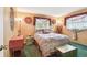 Cozy bedroom featuring carpeted floors, windows with unique floral decor and ample natural light at 855 Pinewood W Ter, Palm Harbor, FL 34683