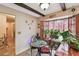Cozy breakfast nook featuring a round table, bay window, and natural light at 855 Pinewood W Ter, Palm Harbor, FL 34683