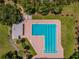 Aerial view showcases a large community pool area with a pool and a variety of amenities at 855 Pinewood W Ter, Palm Harbor, FL 34683