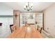 Spacious dining room with large wooden table, display cabinets, and elegant chandelier at 855 Pinewood W Ter, Palm Harbor, FL 34683