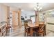 Open-concept dining area with wood table and view of the living room and modern kitchen at 855 Pinewood W Ter, Palm Harbor, FL 34683