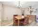 The dining room features a wooden table and chairs, a cabinet, and light fixture at 855 Pinewood W Ter, Palm Harbor, FL 34683