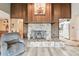 A stone fireplace with a wooden mantle and decorative floral arrangement is the focal point of the living room at 855 Pinewood W Ter, Palm Harbor, FL 34683