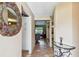 Inviting foyer featuring decorative mirror and console table, leading into living spaces at 855 Pinewood W Ter, Palm Harbor, FL 34683