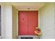A warm welcome, front entrance features double doors and a small decorative table and flowers at 855 Pinewood W Ter, Palm Harbor, FL 34683