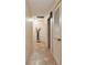 Hallway with tile floors, neutral walls and decorative slat doors at 855 Pinewood W Ter, Palm Harbor, FL 34683