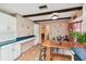 Kitchen with tile floor, wooden beams, bar stool, and decor around the room at 855 Pinewood W Ter, Palm Harbor, FL 34683